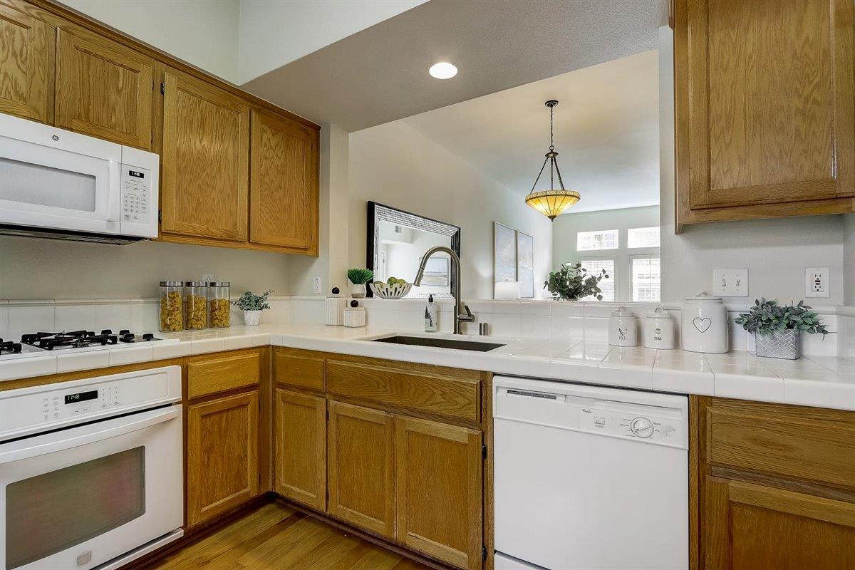633 Swallowtail Court Brisbane, CA 94005 - Photo 14 of 42 a kitchen with stainless steel appliances granite countertop a sink a stove and cabinets