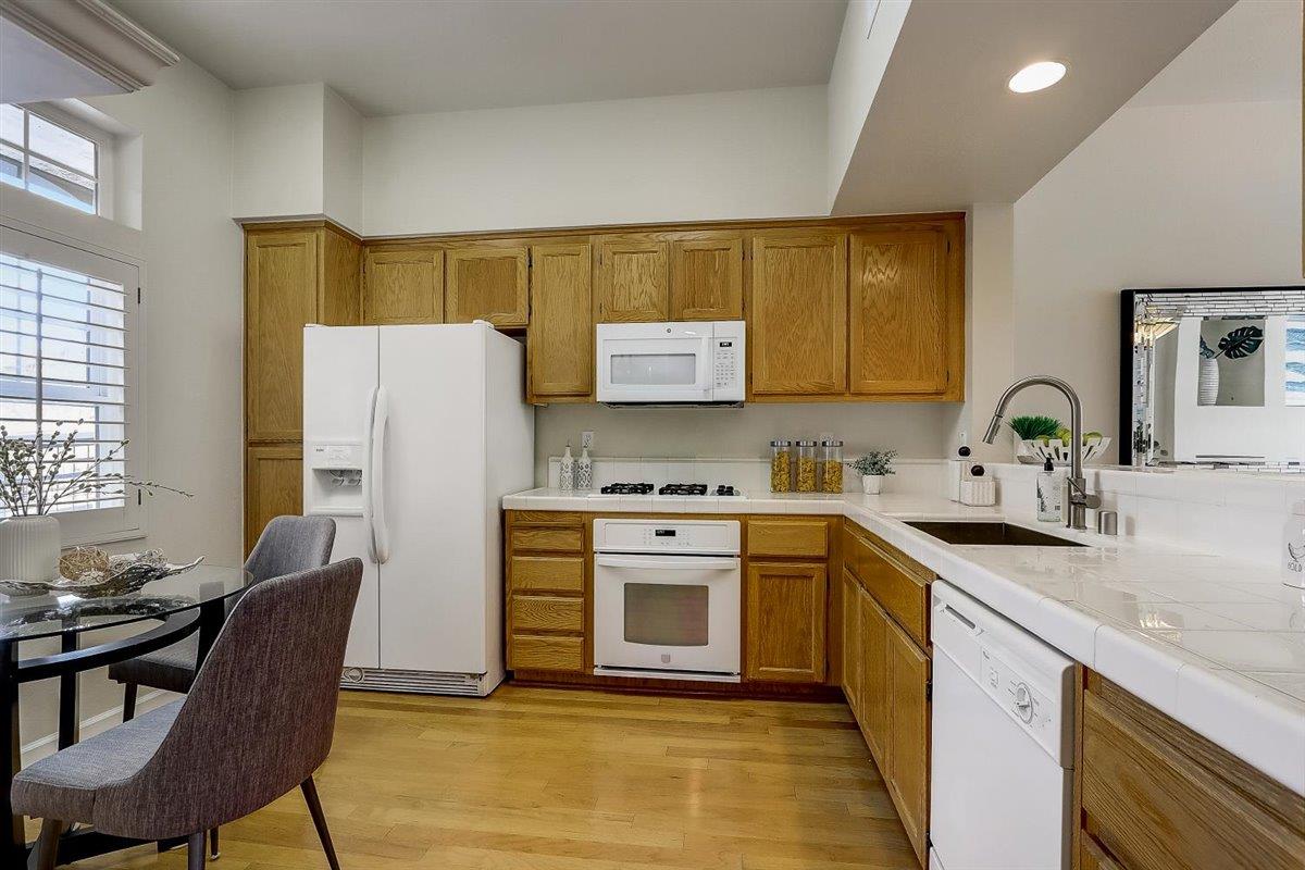 633 Swallowtail Court Brisbane, CA 94005 - Photo 15 of 42 a kitchen with stainless steel appliances granite countertop a sink stove refrigerator and dining table