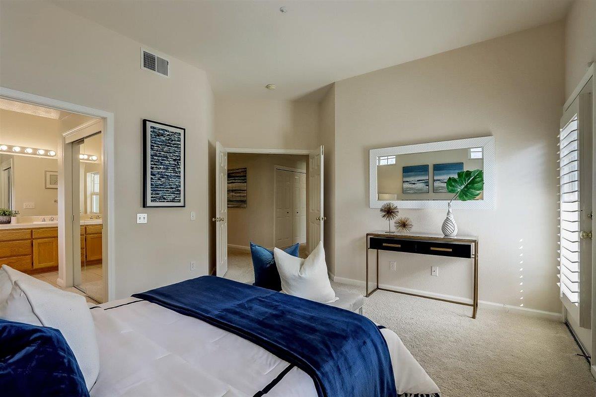 633 Swallowtail Court Brisbane, CA 94005 - Photo 18 of 42 a bedroom with a bed and a potted plant