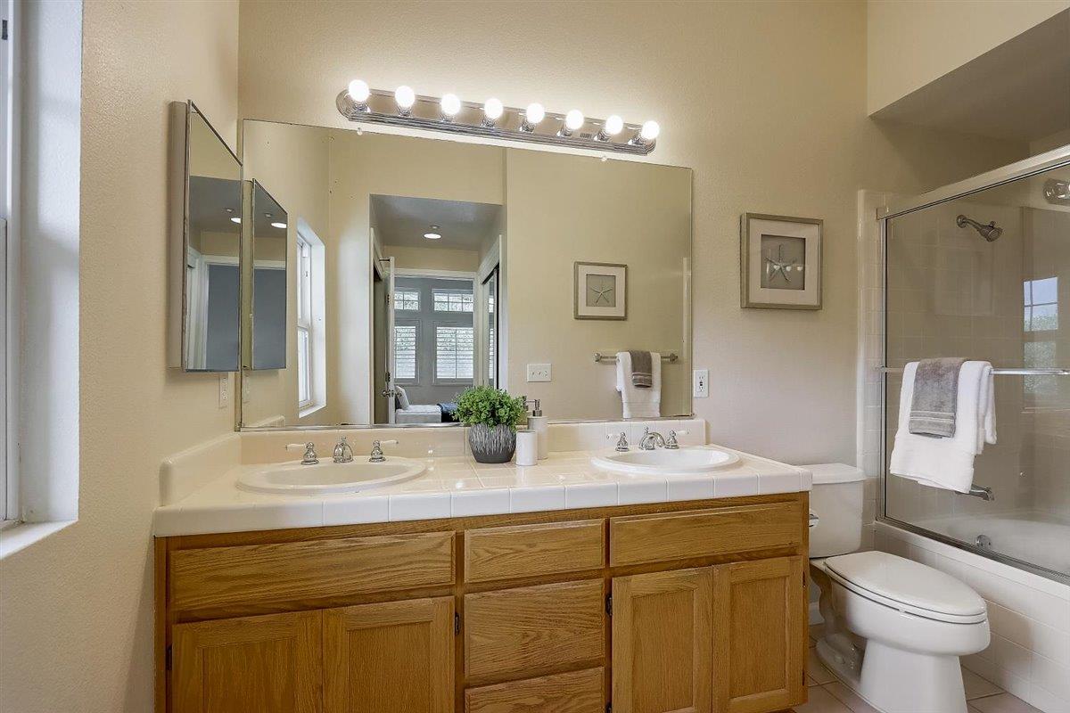 633 Swallowtail Court Brisbane, CA 94005 - Photo 20 of 42 a bathroom with a double vanity sink and a mirror