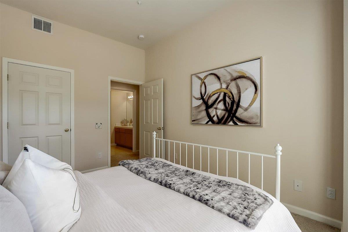 633 Swallowtail Court Brisbane, CA 94005 - Photo 22 of 42 a bedroom with a bed and a couch