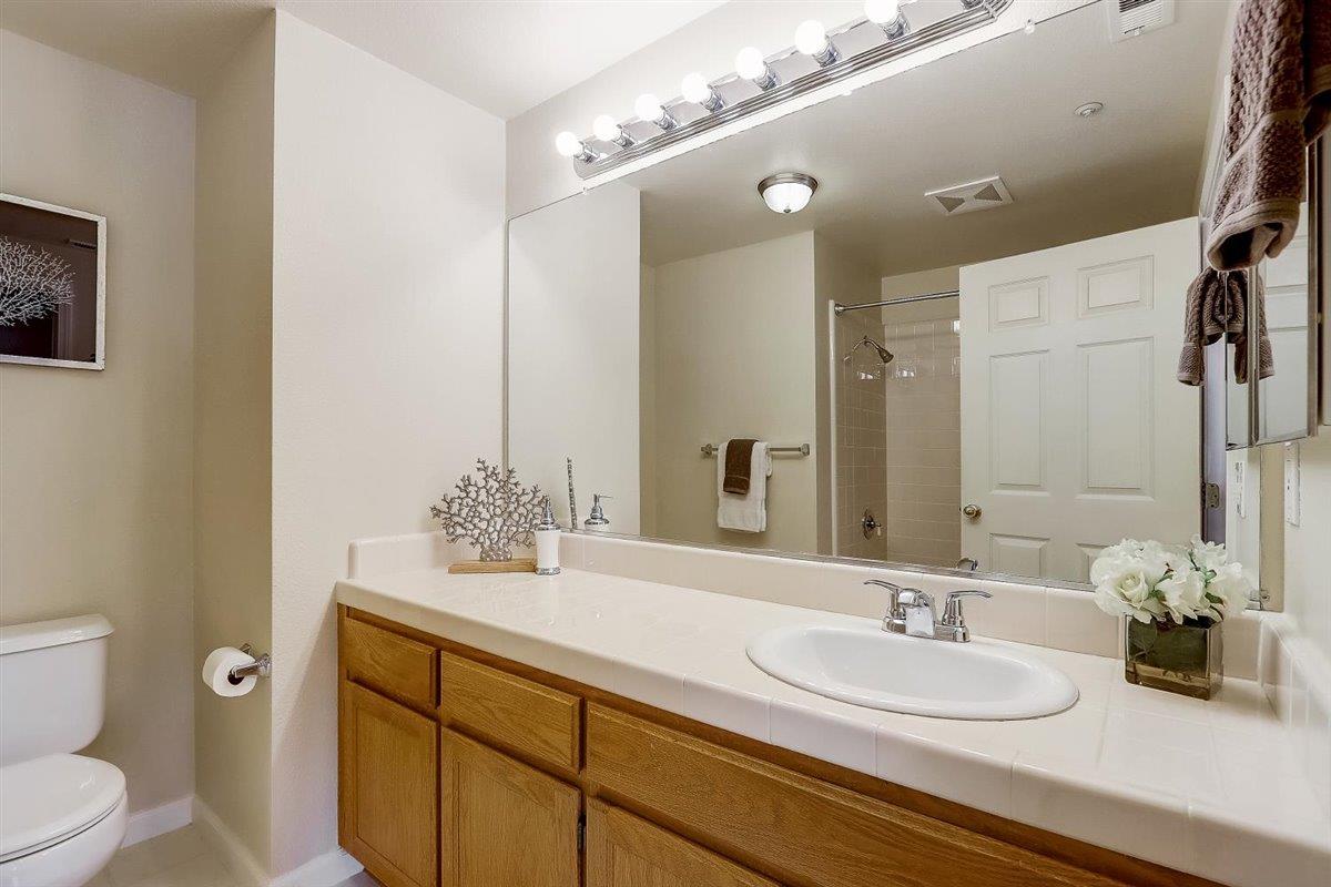 633 Swallowtail Court Brisbane, CA 94005 - Photo 25 of 42 a bathroom with a double vanity sink mirror and toilet