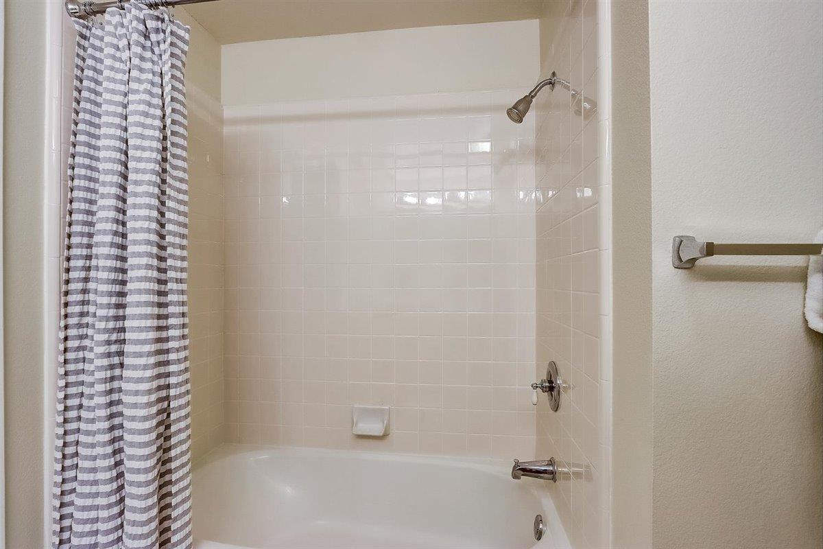633 Swallowtail Court Brisbane, CA 94005 - Photo 26 of 42 a bathroom with a shower and a bath tub
