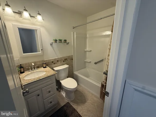 a bathroom with a sink toilet a mirror and shower