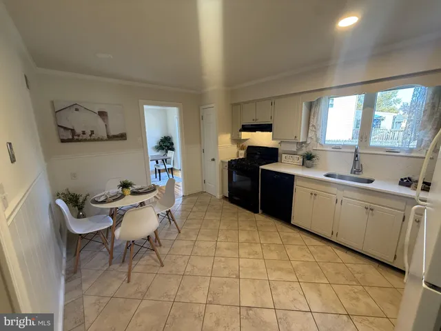 a kitchen with a sink a counter top space and appliances