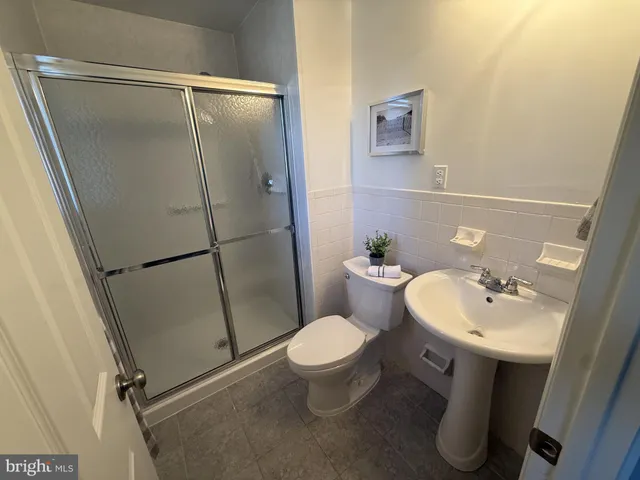 a bathroom with a sink toilet and a mirror