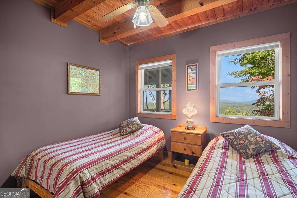 175 Oak Ledge Road Morganton, GA 30560 - Photo 27 of 50 a bedroom with a bed and wooden floor