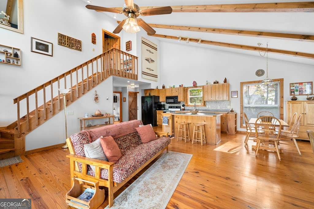 175 Oak Ledge Road Morganton, GA 30560 - Photo 33 of 50 a living room with furniture and a dining table with wooden floor