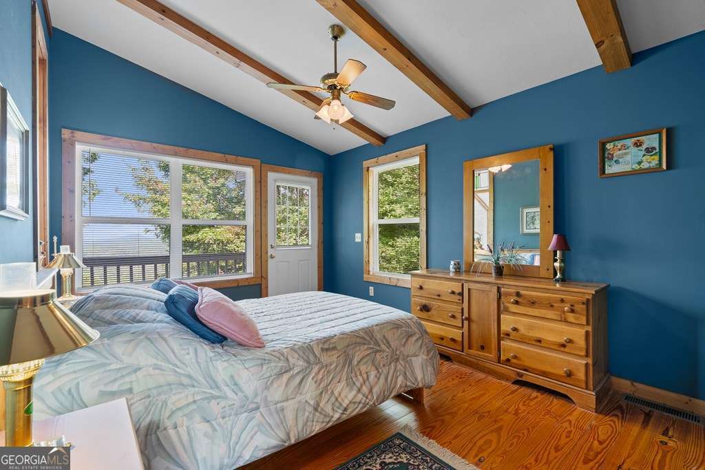 175 Oak Ledge Road Morganton, GA 30560 - Photo 35 of 50 a bedroom with a bed and large windows