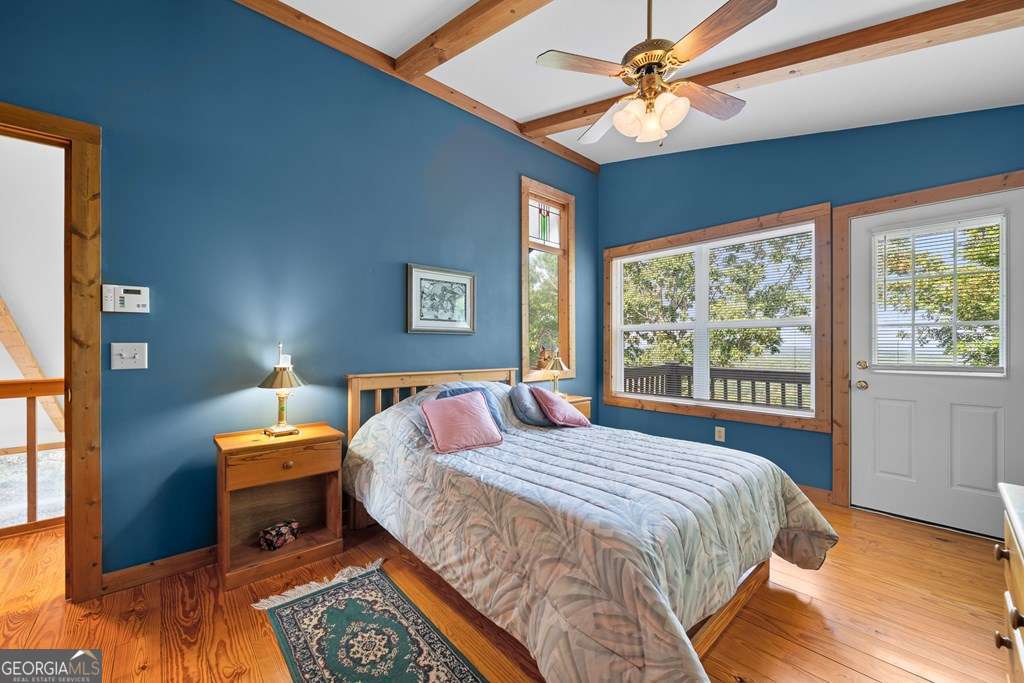 175 Oak Ledge Road Morganton, GA 30560 - Photo 36 of 50 a bedroom with a bed and a chandelier