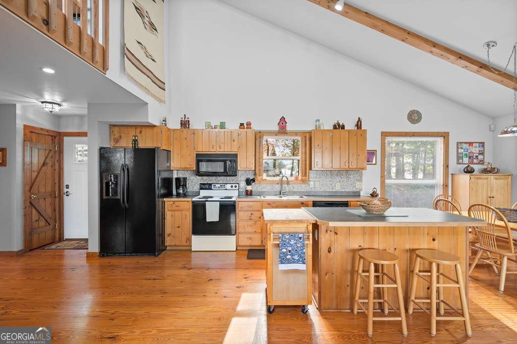 175 Oak Ledge Road Morganton, GA 30560 - Photo 6 of 50 a kitchen with stainless steel appliances granite countertop a refrigerator a stove top oven and a sink