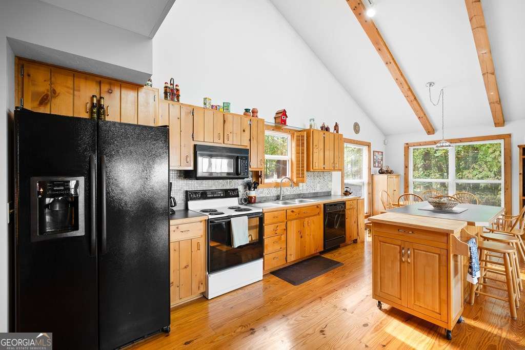 175 Oak Ledge Road Morganton, GA 30560 - Photo 7 of 50 a kitchen with stainless steel appliances granite countertop a refrigerator a stove top oven a sink dishwasher and wooden cabinets