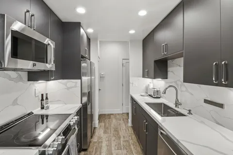 a kitchen with a sink stove and refrigerator