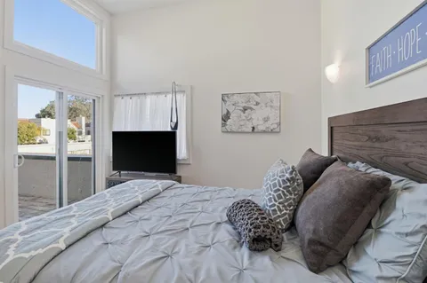 a bedroom with a bed and a fireplace