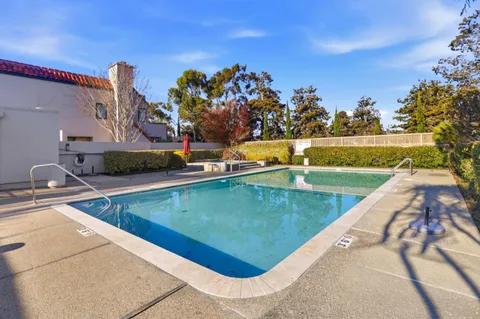 a view of a swimming pool with a yard