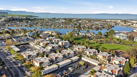 an aerial view of residential houses with city view