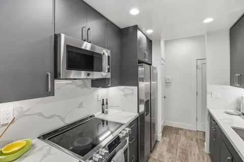 a kitchen with a sink and a stove top oven