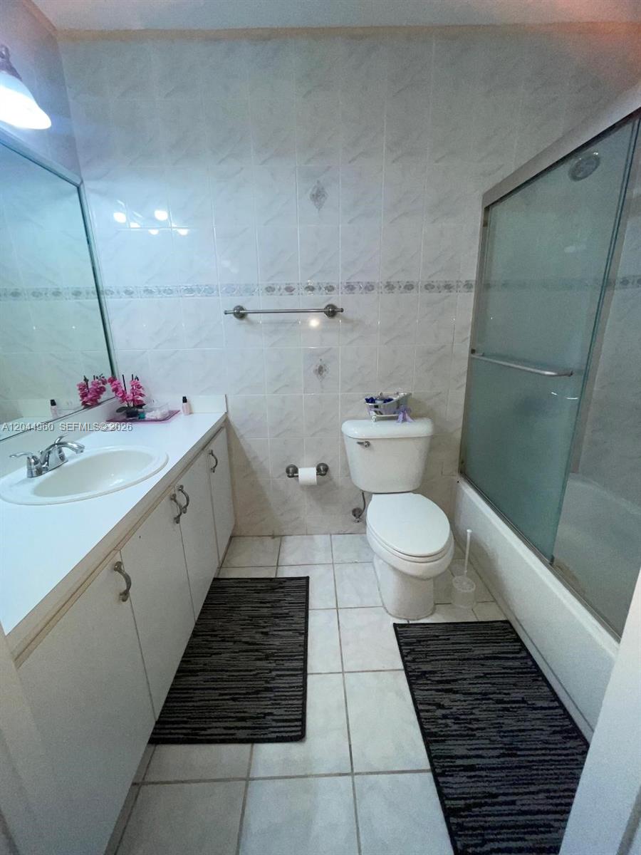 7681 Northwest 178th Terrace Hialeah, FL 33015 - Photo 7 of 11 a bathroom with a sink and a mirror