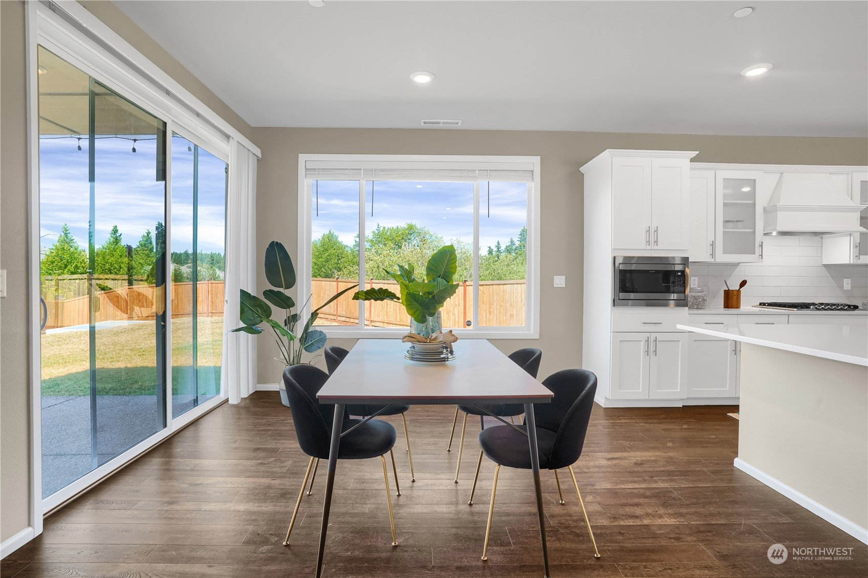 8808 Northeast 201st Place Bothell, WA 98011 - Photo 12 of 38 a view of a dining room with furniture window and wooden floor