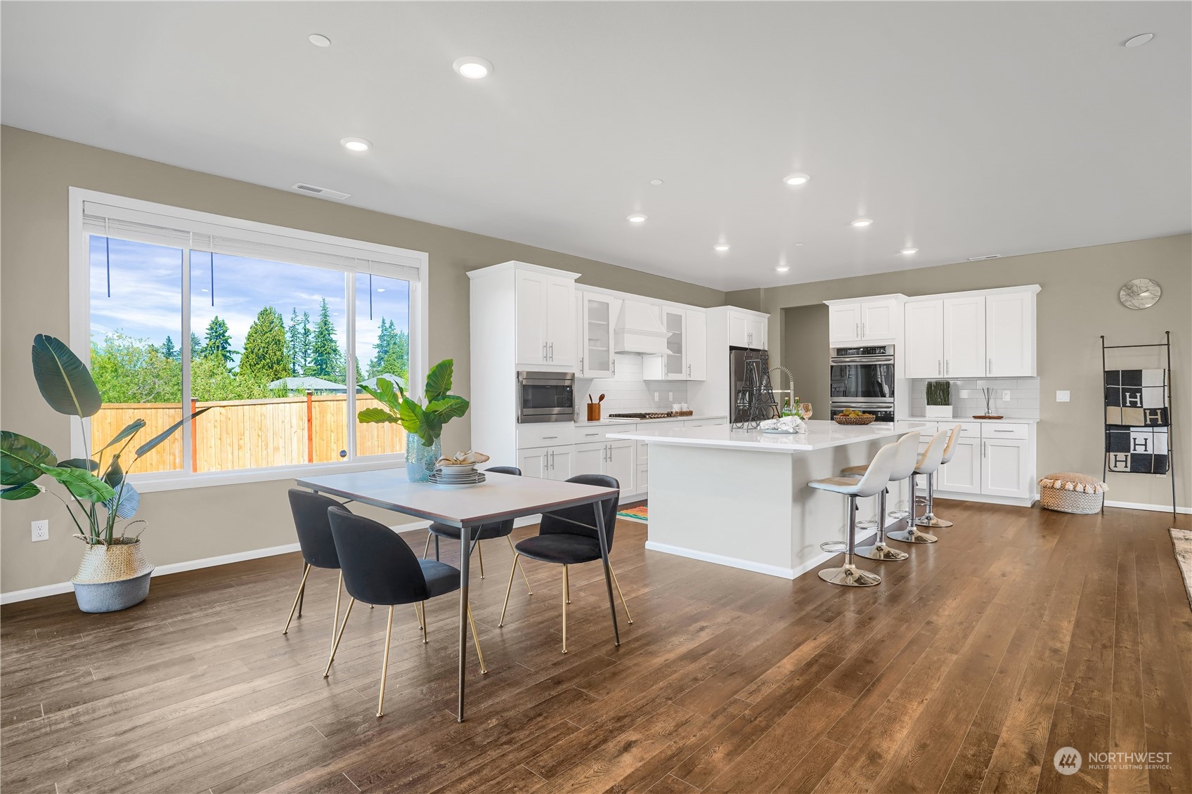 8808 Northeast 201st Place Bothell, WA 98011 - Photo 14 of 38 a living room with stainless steel appliances kitchen island granite countertop furniture a rug kitchen view and a large window