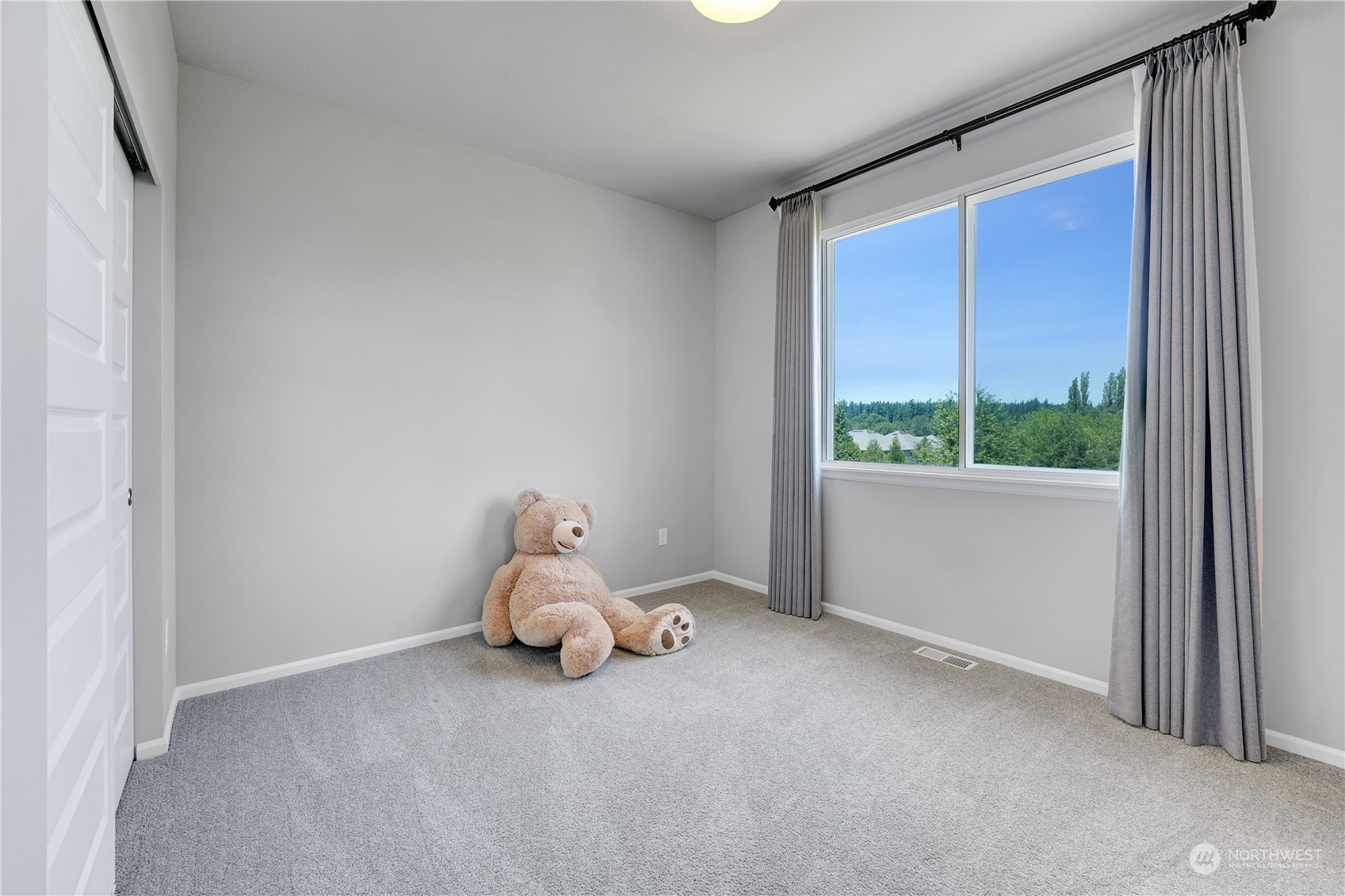 8808 Northeast 201st Place Bothell, WA 98011 - Photo 25 of 38 a room with a large window and bed