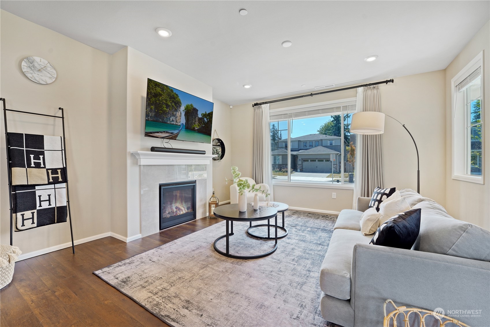 8808 Northeast 201st Place Bothell, WA 98011 - Photo 3 of 38 a living room with furniture a fireplace and a flat screen tv