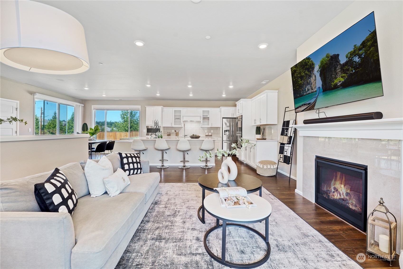 8808 Northeast 201st Place Bothell, WA 98011 - Photo 4 of 38 a living room with furniture a flat screen tv and a fireplace
