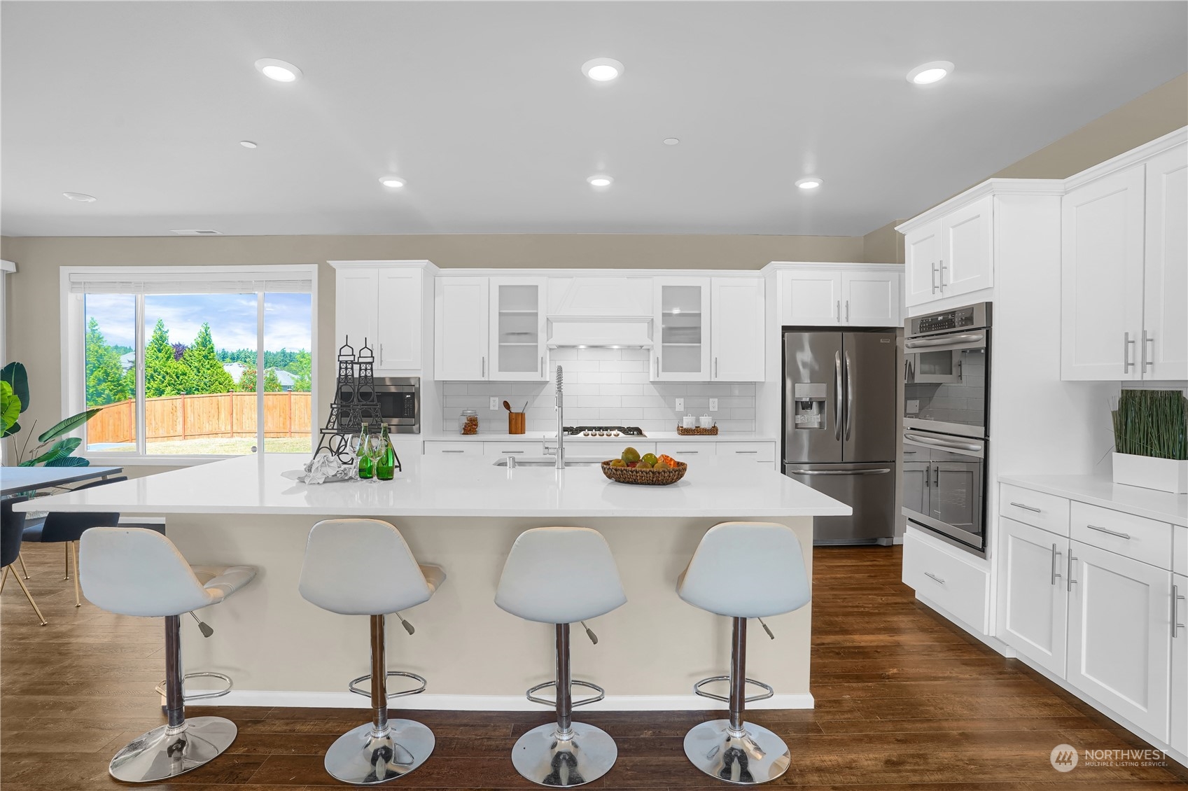8808 Northeast 201st Place Bothell, WA 98011 - Photo 5 of 38 a kitchen with stainless steel appliances a dining table chairs and refrigerator