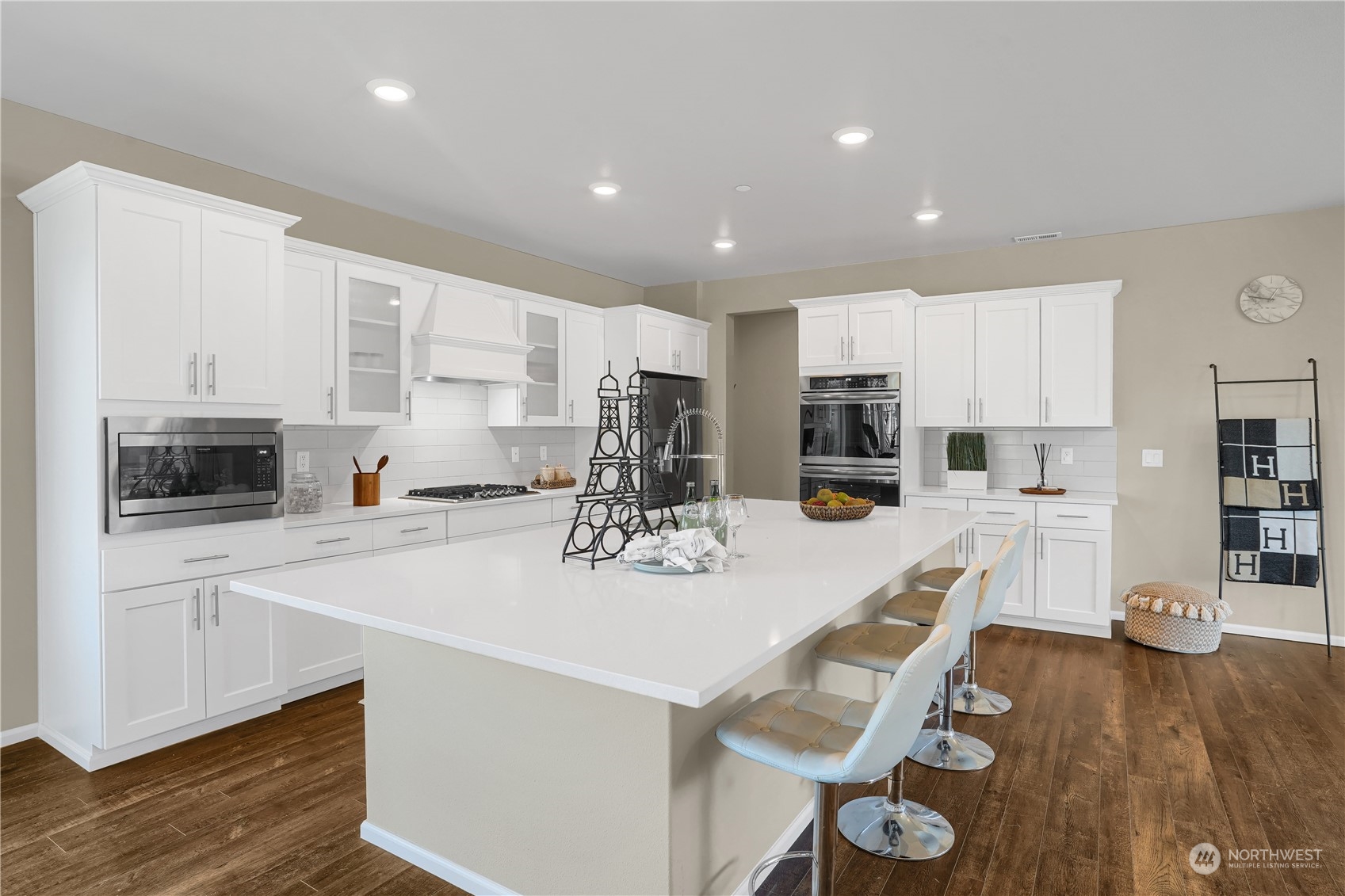 8808 Northeast 201st Place Bothell, WA 98011 - Photo 6 of 38 a kitchen with a dining table chairs and white cabinets