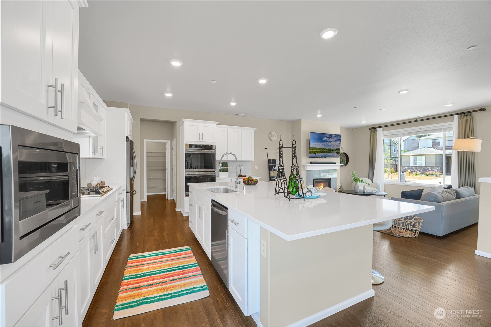 8808 Northeast 201st Place Bothell, WA 98011 - Photo 8 of 38 a kitchen with stainless steel appliances kitchen island granite countertop a refrigerator and a sink