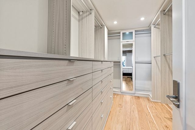 a view of walk in closet with empty racks