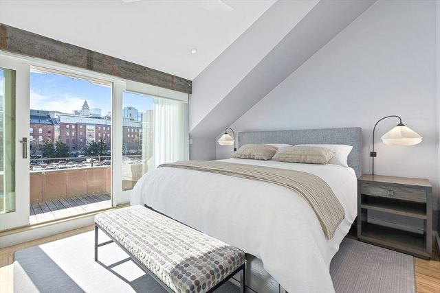 a bedroom with a bed and glass window