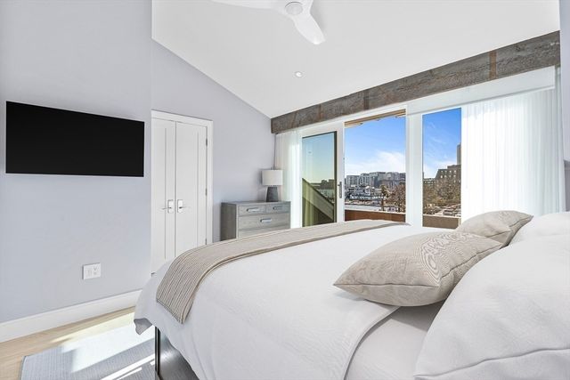 a bedroom with a bed and a flat screen tv