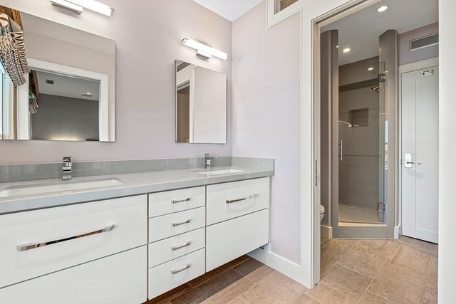 a bathroom with double sink and a mirror