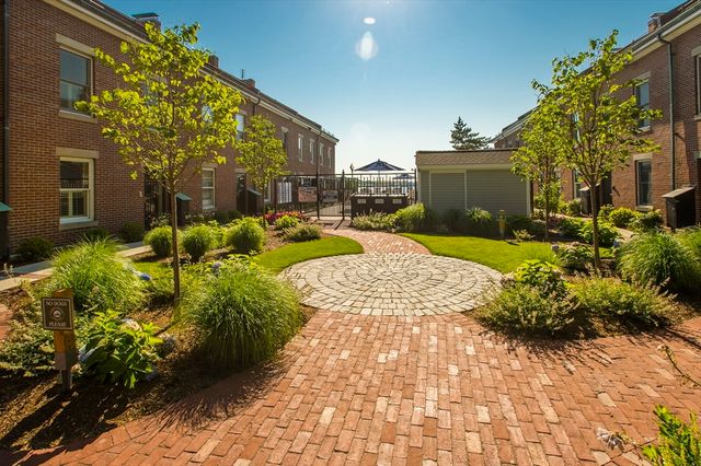 a view of backyard with plants and outdoor seating