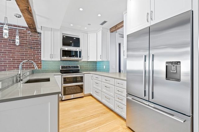 a kitchen with granite countertop stainless steel appliances and counter space