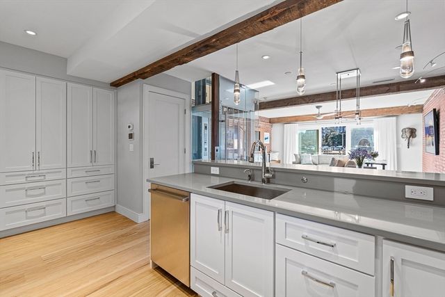 a kitchen with kitchen island white cabinets and counter space