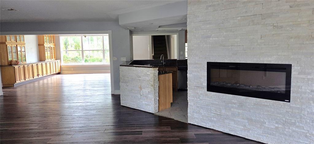 2766 Duffer Road Sebring, FL 33872 - Photo 12 of 63 a living room with wooden floor and a fireplace