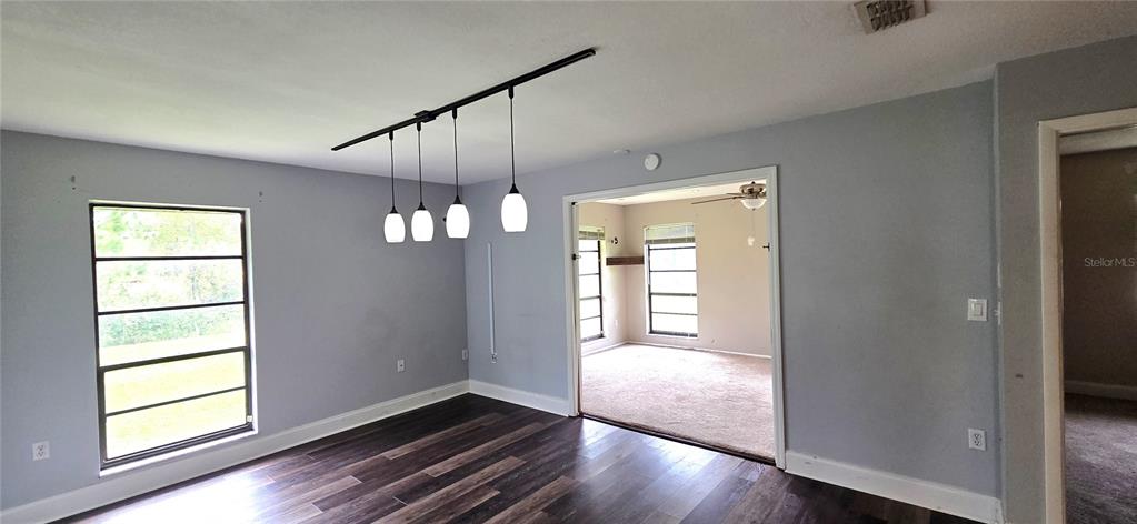 2766 Duffer Road Sebring, FL 33872 - Photo 21 of 63 a view of an empty room with wooden floor and a window