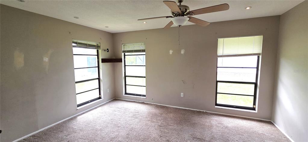 2766 Duffer Road Sebring, FL 33872 - Photo 23 of 63 an empty room with windows and ceiling fan