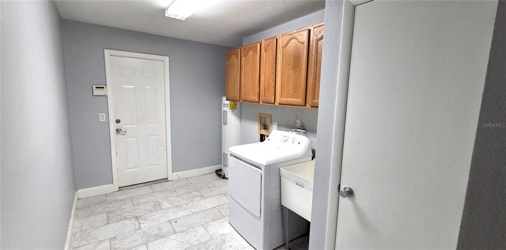 2766 Duffer Road Sebring, FL 33872 - Photo 27 of 63 a bathroom with a sink a washer and dryer