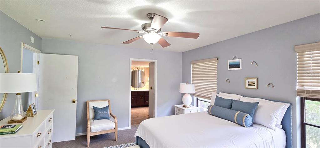 2766 Duffer Road Sebring, FL 33872 - Photo 29 of 63 a bedroom with a bed and a chandelier