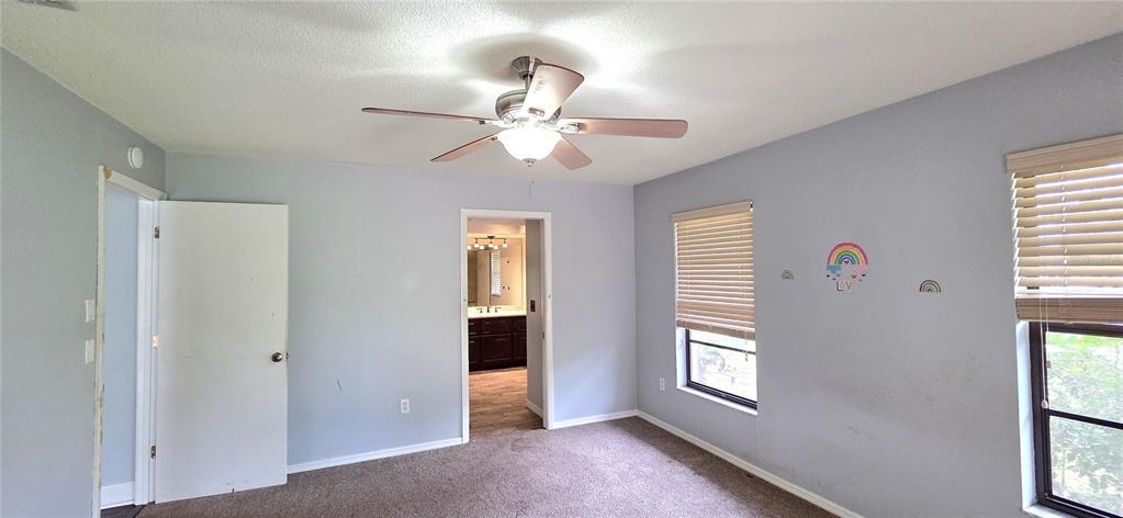 2766 Duffer Road Sebring, FL 33872 - Photo 30 of 63 a view of an empty room with a window and a kitchen