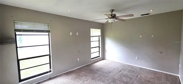 a bathroom with a granite countertop sink a mirror and shower