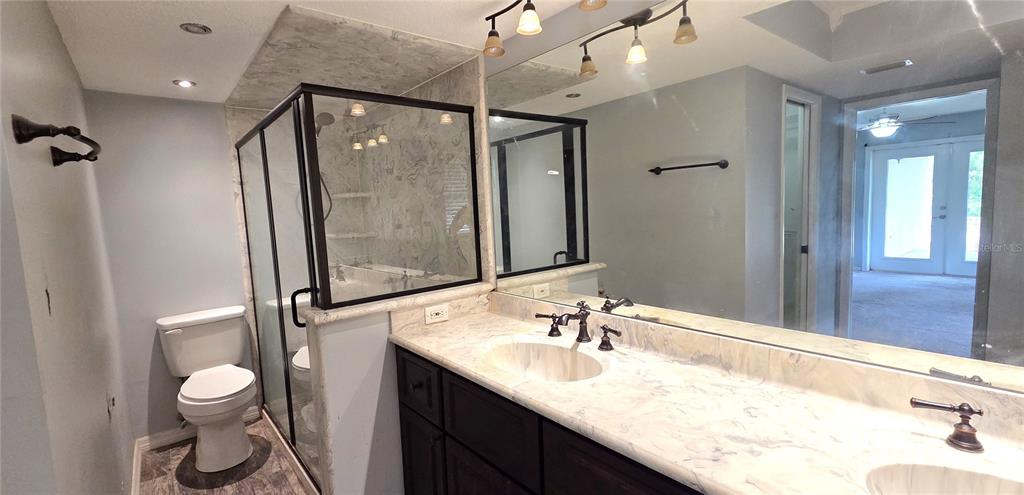 2766 Duffer Road Sebring, FL 33872 - Photo 34 of 63 a bathroom with a granite countertop sink a toilet and shower