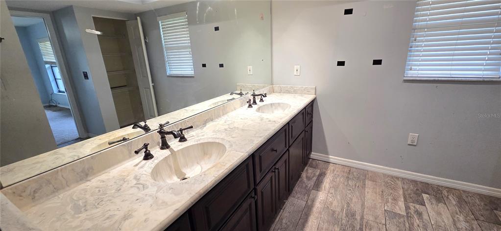 2766 Duffer Road Sebring, FL 33872 - Photo 36 of 63 a bathroom with a granite countertop sink a mirror and shower