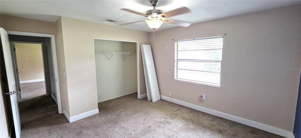 2766 Duffer Road Sebring, FL 33872 - Photo 44 of 63 an empty room with windows and fan