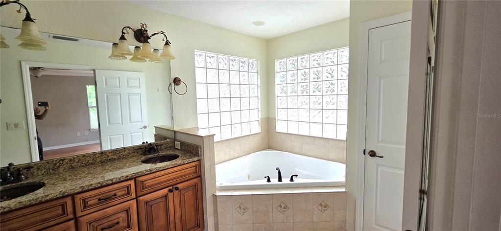 2766 Duffer Road Sebring, FL 33872 - Photo 52 of 63 a bathroom with a tub sink and mirror