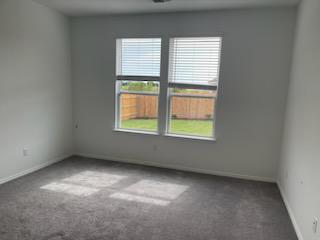 1509 Hope Rnch Road Leander, TX 78641 - Photo 12 of 25 Carpeted empty room with baseboards