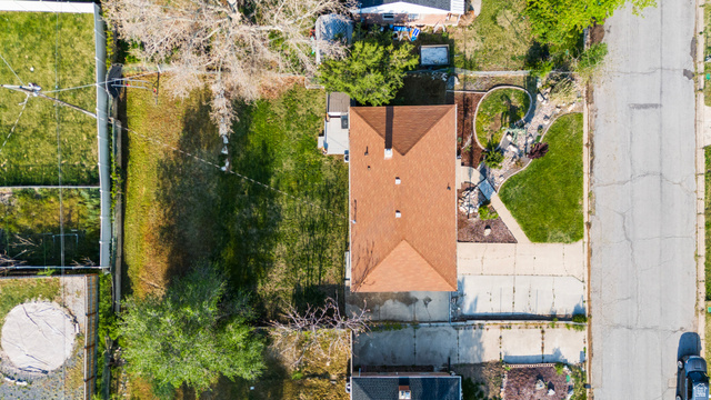 2101 West 3900th Street South Roy, UT 84067 - Photo 33 of 36 Single-story residence featuring a brown shingle roof, two chimneys, and an expansive rear lawn